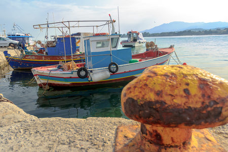 Greek fishing moored motor boats are floating near concrete Mastihari bay on Greek Kos islandの写真素材