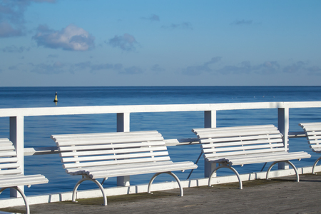 White comfort benches on sea walking pedestrian pierの写真素材