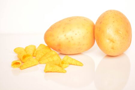 Fresh potatoes and chips on white backgroundの写真素材