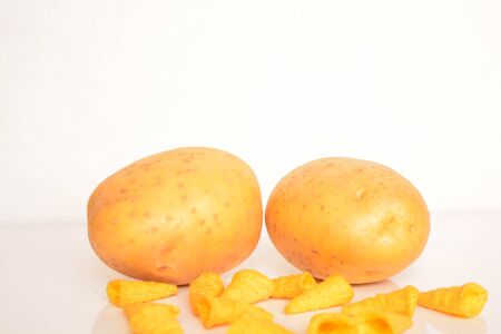 Fresh potatoes and chips on white backgroundの写真素材