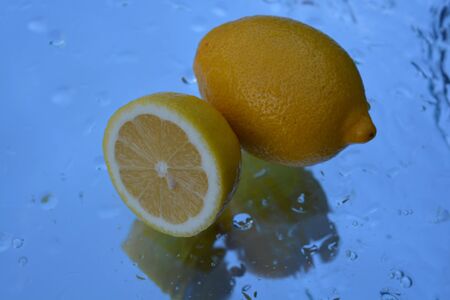 Lemons, reflection in waterの写真素材