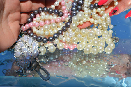 Woman hands and  jewelry on water background, pure water