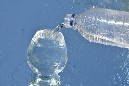 A cup of pure water on water backgroundの写真素材