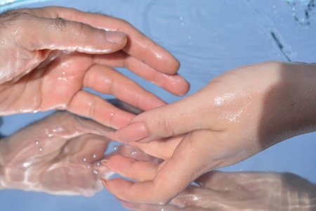 Hands on water background, pure water, drink, drops