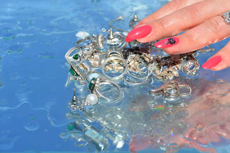 Woman hands and  jewelry on water background, pure waterの写真素材