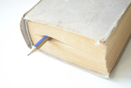 A book and pencil on white backgroundの写真素材