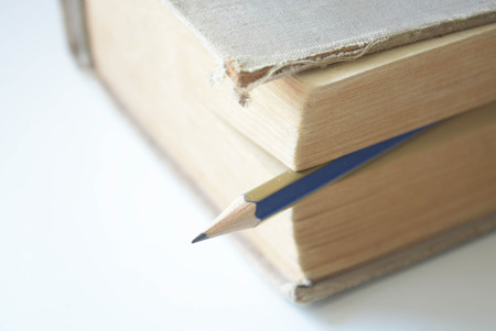 A book and pencil on white backgroundの写真素材