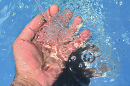 Hands on water backgroundの写真素材