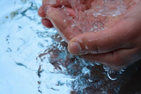 Hands on water backgroundの写真素材