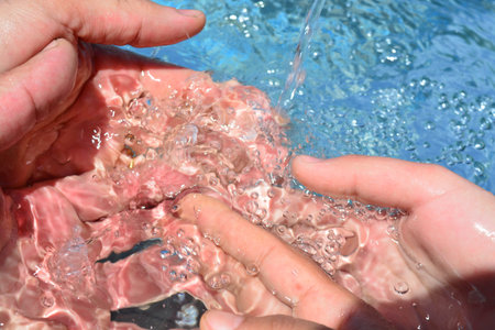 Hands on water backgroundの写真素材