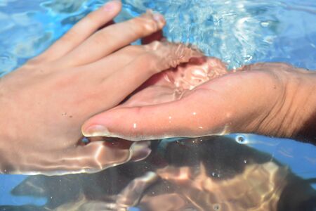 Hands on water backgroundの写真素材