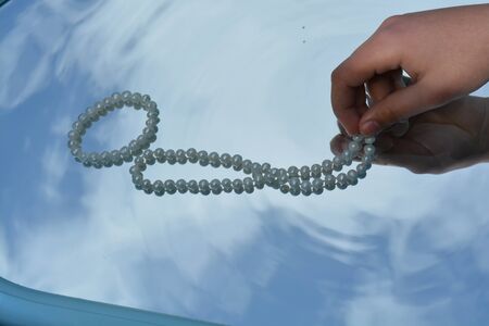 Pearls and hands reflected in pure waterの写真素材