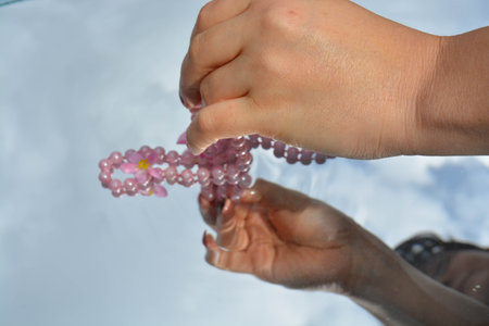 Pearls and hands reflected in pure water