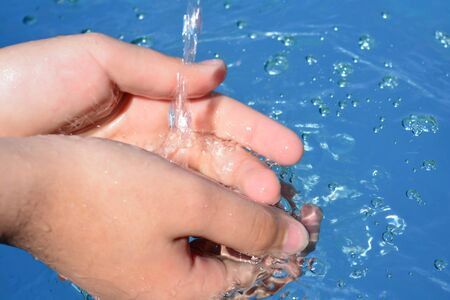 Hands on water backgroundの写真素材