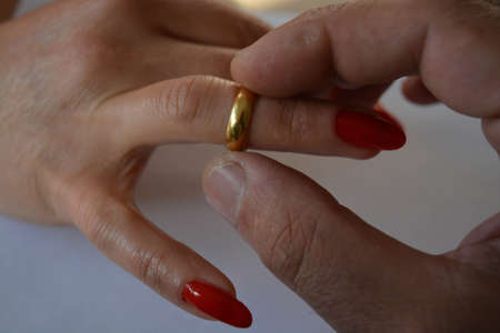 Two hands and wedding gold ringの写真素材