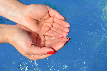Hands on water background, pure water, drink, dropsの写真素材