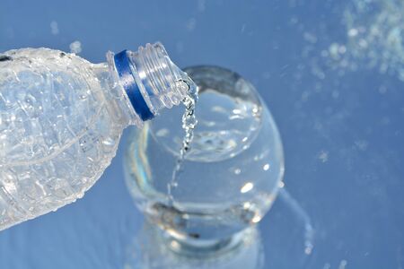 A cup of pure water on water backgroundの写真素材