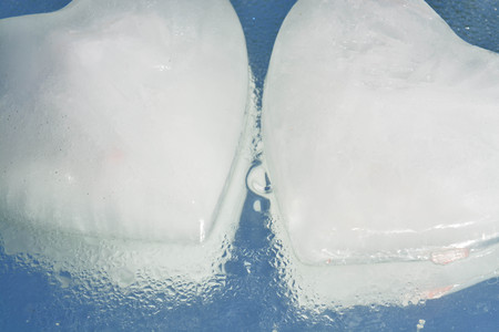 Ice heart on water backgroundの写真素材