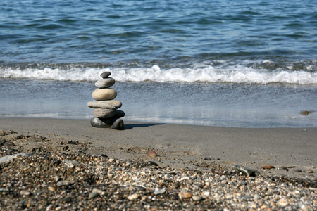 Stacked stones representing the zen symbol on the beach. Focus on the stones.