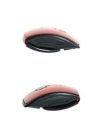 Red and black wireless mouse folded to a half size. Isolated on teh white background.の写真素材