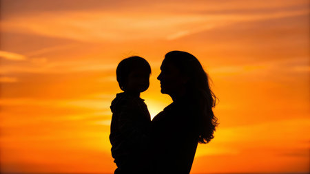 Embracing sunset silhouette of a mother and child beach photography warm colors close-up loveの素材