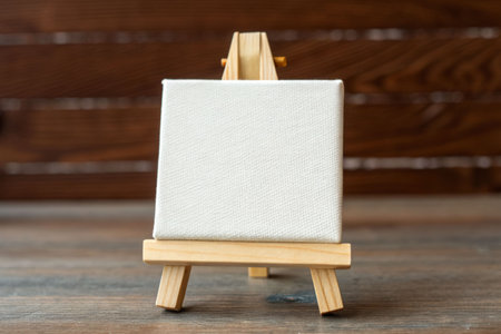 Artistic close-up view of a blank canvas on easel in a creative studio environmentの素材