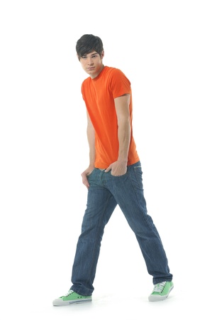 Young man standing with hands in pocketsの写真素材