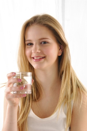 Young happy woman drinking milkの写真素材
