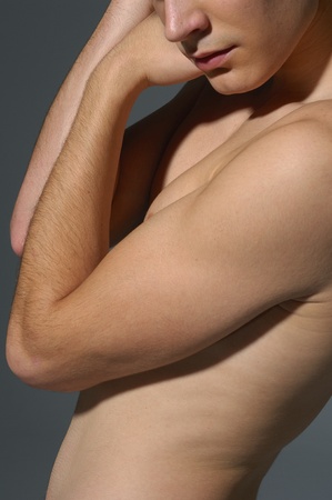young sensual man on a gray backgroundの写真素材