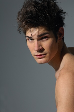 Handsome young man on grayの写真素材