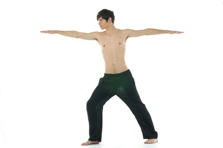 Young man doing yoga in the roomの写真素材