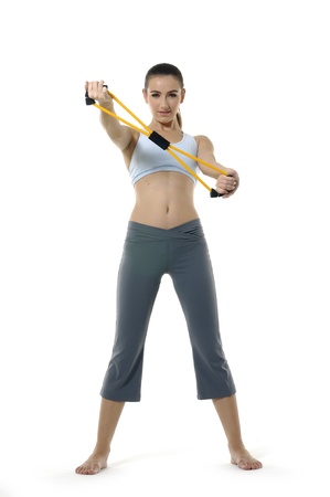 young girl woman exercising with expanderの写真素材