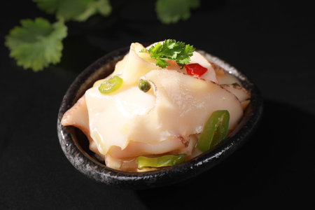 Japanese food, Pickled radish in soy sauce on black background