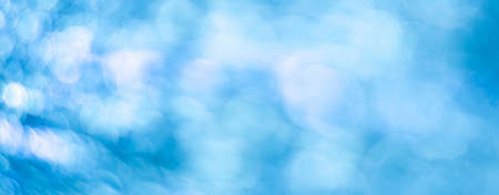 Blue abstract background with bokeh defocused lightsの写真素材