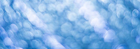 Blue abstract background with bokeh defocused lightsの写真素材