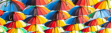 Colorful umbrellas Blue, green, red, rainbow umbrellas background Street with umbrellasin the skyの写真素材