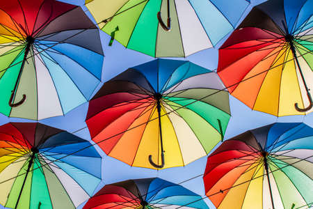 Colorful umbrellas Blue, green, red, rainbow umbrellas background Street with umbrellasin the skyの写真素材
