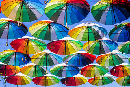 Colorful umbrellas Blue, green, red, rainbow umbrellas background Street with umbrellasin the skyの写真素材