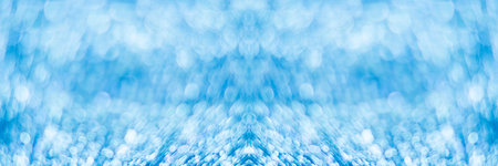 Silver glitter festive background with bokeh lights.