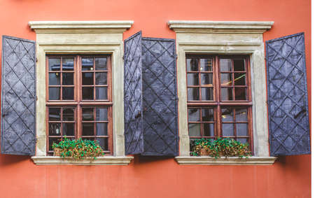 Old windows on the background of an orange wall in the old courtyard of the city.の写真素材