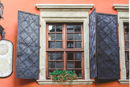 Old windows on the background of an orange wall in the old courtyard of the city.の写真素材