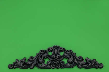 Vintage royal silver horizontal background with black ornaments on a green wallの写真素材