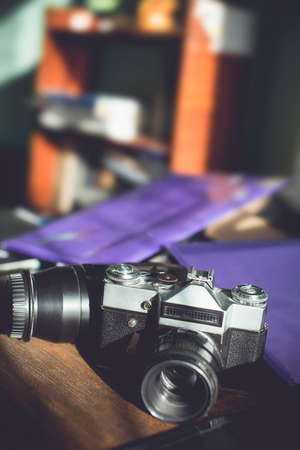 Retro photo camera on a wooden table. vintage style.の写真素材