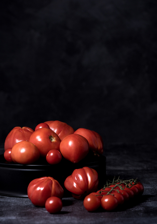 tomatoes  composition on black isolated  background ,  many
 brandの写真素材