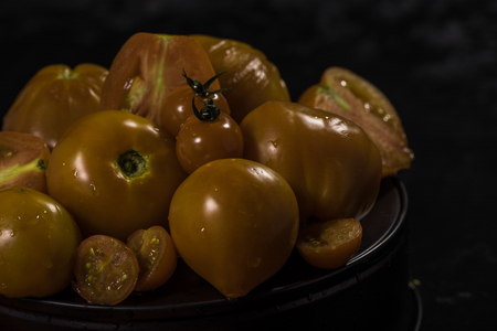 yellow tomatoes  composition on black isolated  background ,  many
 brandの写真素材