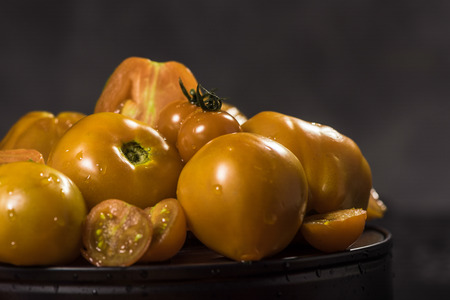 yellow tomatoes  composition on black isolated  background ,  many
 brandの写真素材