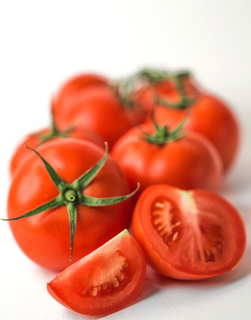 Fresh red tomatoes on white isolated backgroundの写真素材