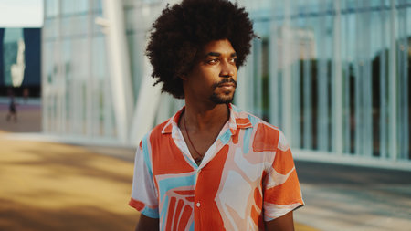 Close-up portrait of smiling young African American man wearing shirt standing on an urban street background. lifestyle concept.の写真素材