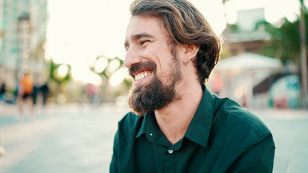 Close-up portrait of a smiling man with a beard on an urban city background with ice cream in his hands. Frontal close-up of a happy young hipster male testing ice cream on a warm sunny dayの写真素材