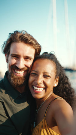 Close up portrait of happy man and smiling woman doing stream on smartphone. Close-up, joyful young...